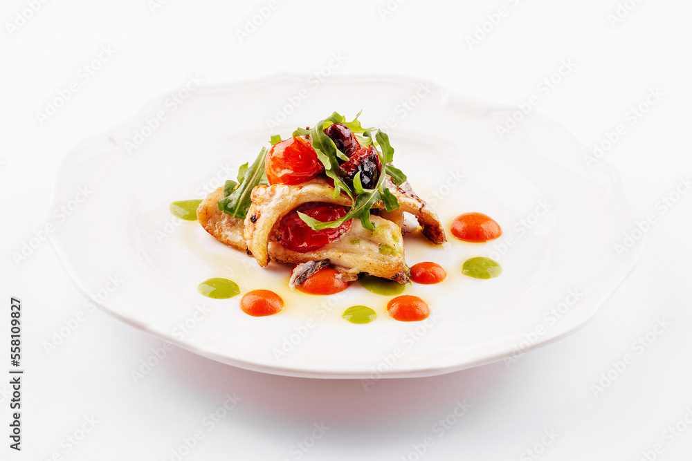 Fried white fish fillet with tomatoes and arugula Fried white fish fillet with tomatoes and arugula