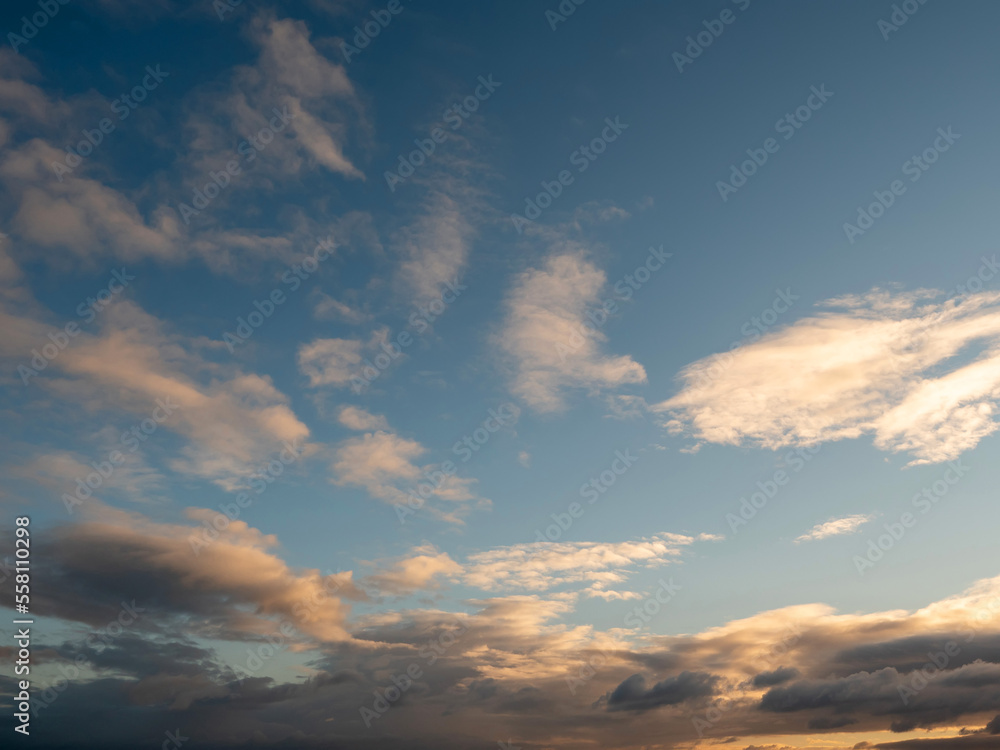 Beautiful cloudy sky with rich blue color at sunset. Nature background for design and sky replacement.