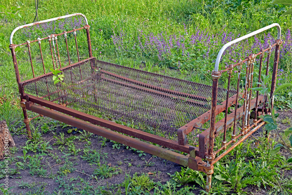 Old iron bed on a green meadow. Kharkov, Ukraine Old iron bed on a green meadow. Kharkov, Ukraine