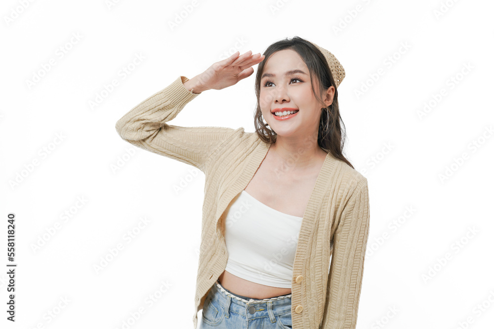 Portrait of smiling cheerful Asian young woman raise hand her hand at the forehead and looking up. Portrait of smiling cheerful Asian young woman raise hand her hand at the forehead and looking up.