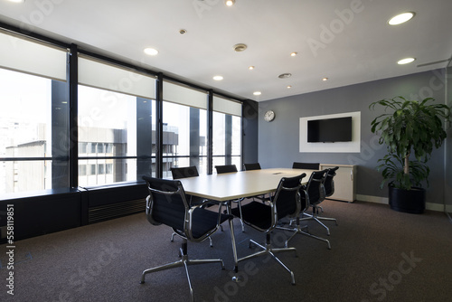 Tableau sur toile Modern boardroom of a modern office with long wooden table with swivel chairs an
