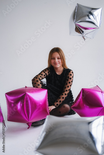 Young teen modern stylish girl in black dress on isolated background