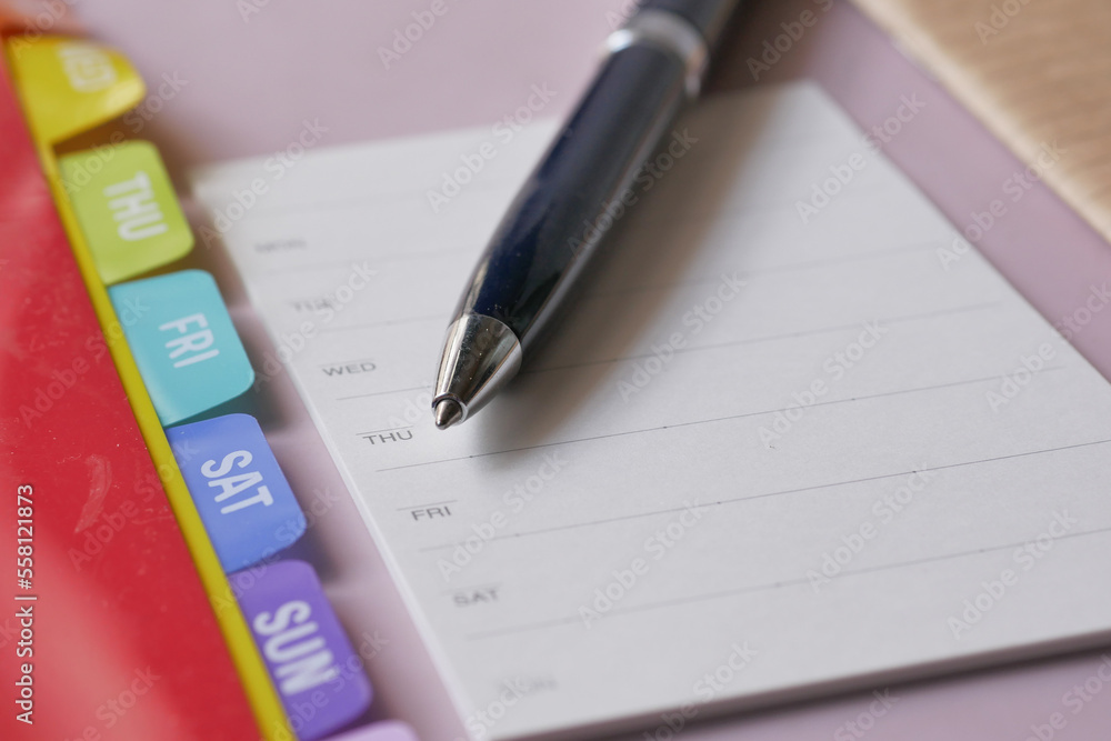 weekly planner and notepad on table weekly planner and notepad on table