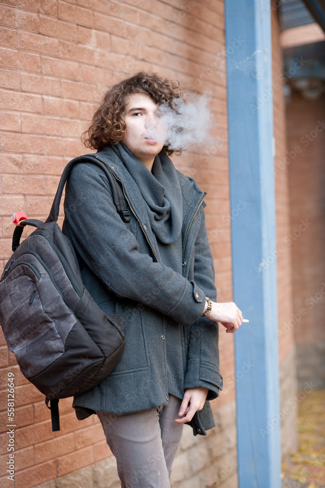 Portrait of a handsome man smoking a cigarette.