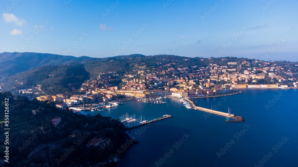 Top view of the small town of Porto Santo Stefano, Tuscany Italy at sunset. Harbor with boats, fishing boats, emerald coast and city