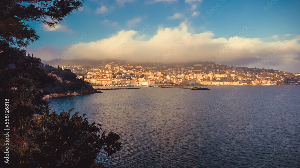 Top view of the small town of Porto Santo Stefano, Tuscany Italy at sunrise. Harbor with boats, fishing boats, emerald coast and city in the distance. Rocks and seagulls
