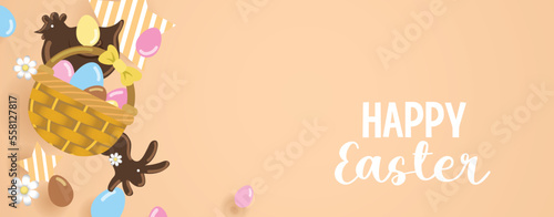 Wicker basket with chocolate easter eggs and chocolate chicken and rabbit. Springtime happy easter banner template.