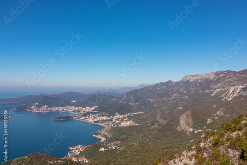 Panoramic aerial view on the coastline of Budva and Sveti Nikola Island seen from Goli Vrh, Adriatic Mediterranean Sea, Montenegro, Balkan, Europe. Luxury hotel resorts along Budvanian Riviera.