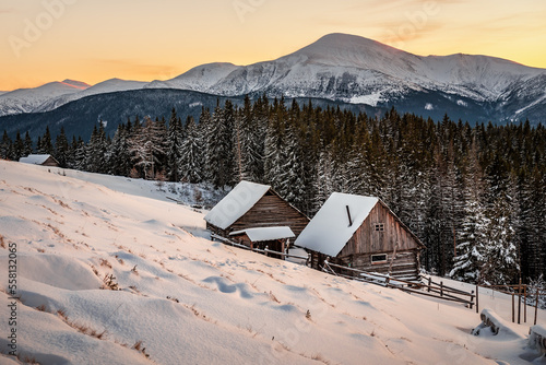 Cuadro en lienzo Beautiful winter landscape with cabins at amazing sunset in the snowy mountains