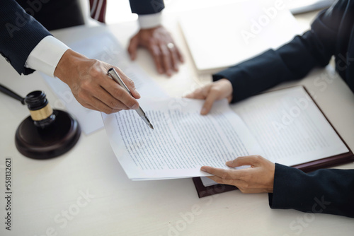 Photos Lawyer with lawsuit meeting with client discussing with contract agreement at co