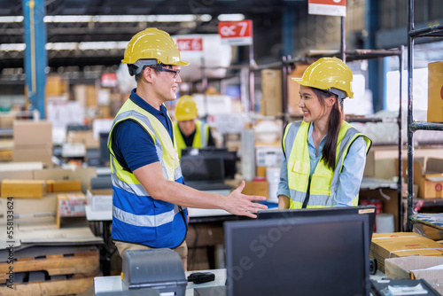 Staff working in large depot storage warehouse trainee check packing box and scan at cashier counter