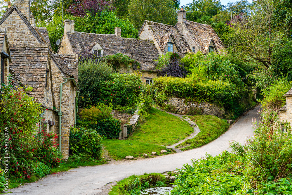 Traditional row of stone cottage houses on Arlington Row in Bibury village, Gloucestershire, The Cotswolds, England UK