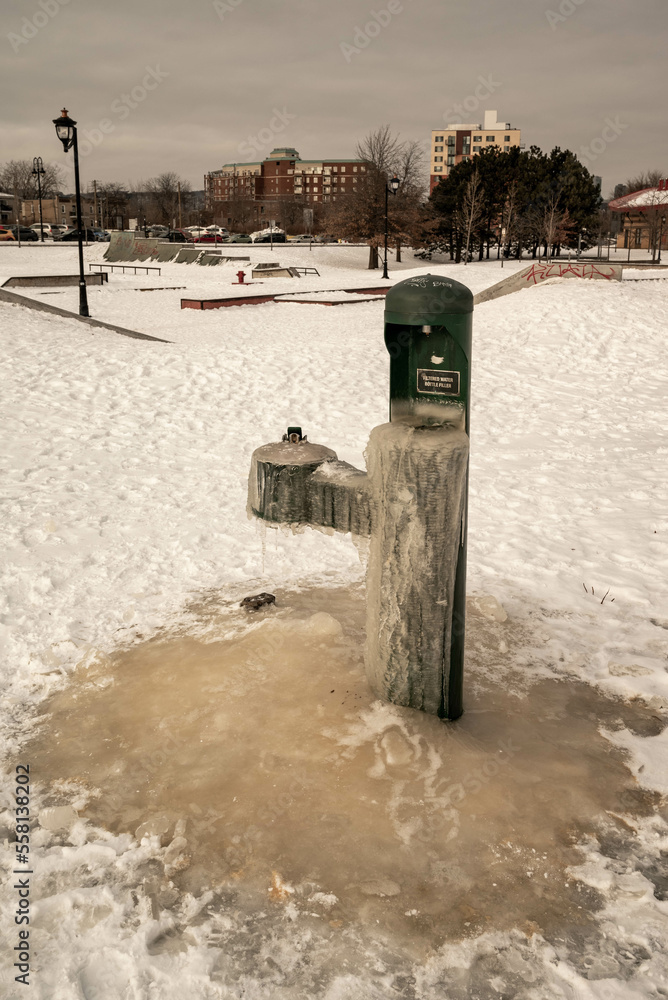 Water fountain. Free drinking water fountain in Quebec. Free drinking water fountain in the ice. frozen drinking water