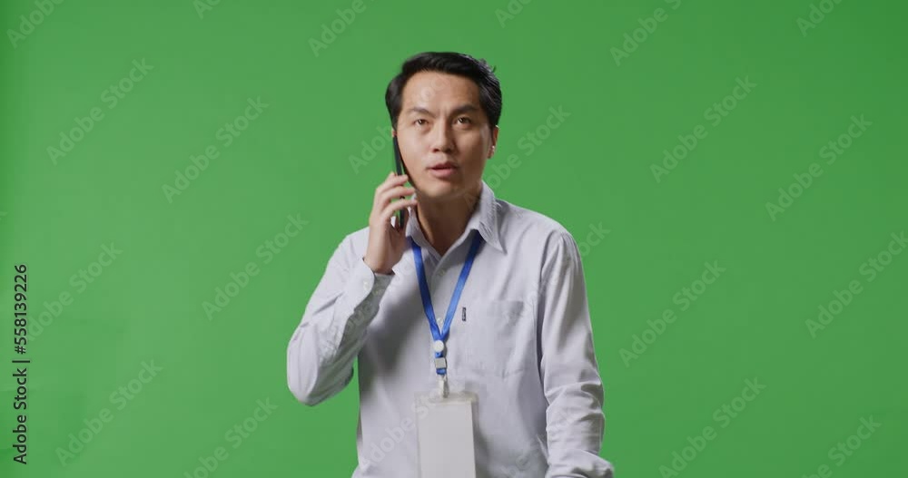 Asian Business Man Talking On Mobile Phone While Walking On Green Screen In The Studio
Asian Business Man Talking On Mobile Phone While Walking On Green Screen In The Studio