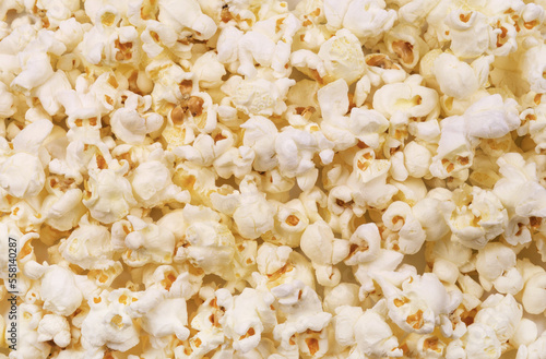 Fresh popcorn close up. Background of popcorn flakes, top view.