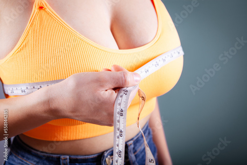 young girl measures breast girth on