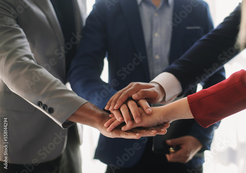 Close up on hands of business people join together their hands together on unity concept