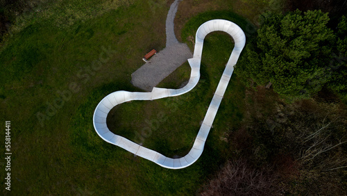 bike path in the car park Pumping (moving up and down) is used instead of pedaling and bouncing to move bicycles, scooters, skateboards and inline skates along the modular pumptrack track photo