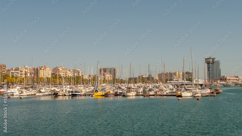 Barcelona, Spain – July 19, 2012: Marina with yachts and boats in downtown of Barcelona at summer sunny hot day and blue sky during warm sunset colors.