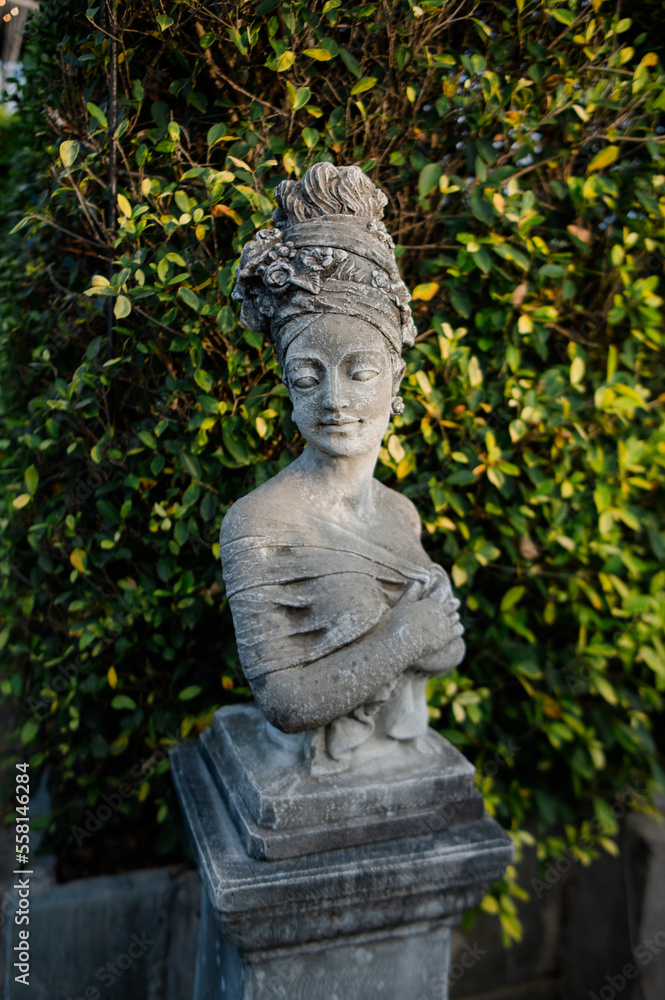 Statues in various postures placed in the garden Statues in various postures placed in the garden