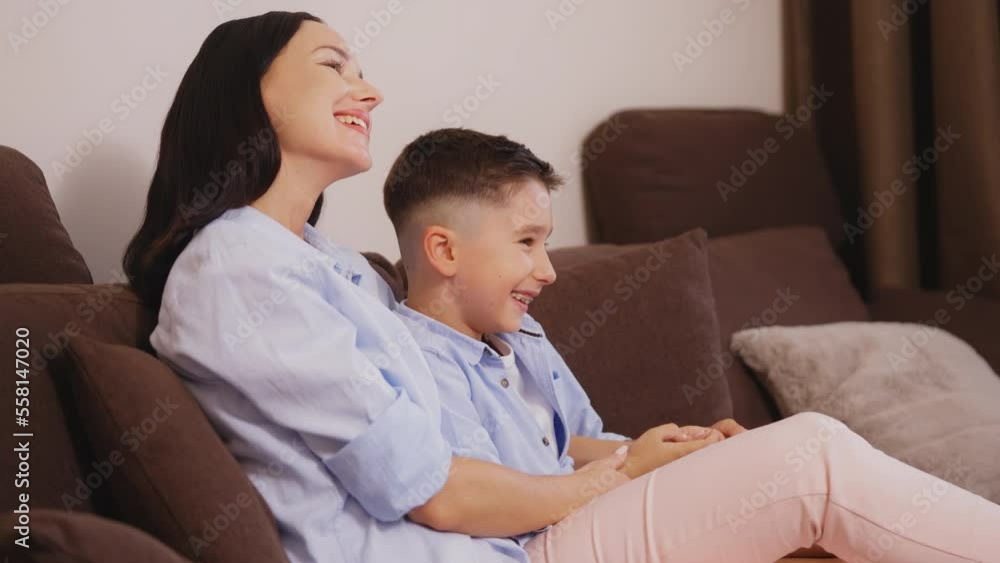 Woman and her son having fun while watching movie together, entertainment Woman and her son having fun while watching movie together, entertainment