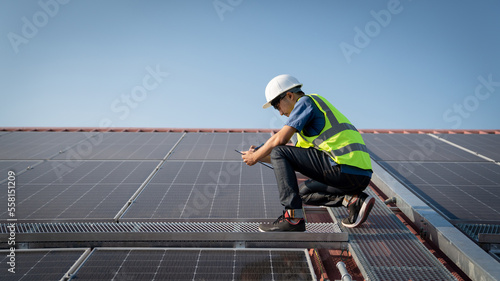 Service engineer checking solar cell on the roof  for maintenance if there is a damaged part., Clean energy concept.