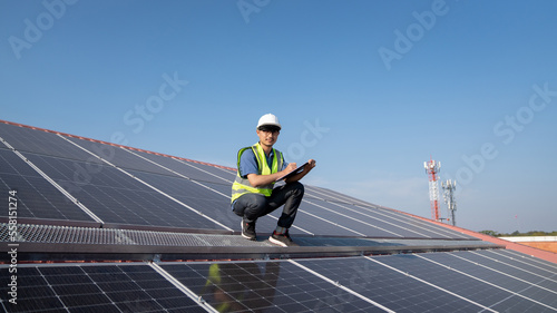 Service engineer checking solar cell on the roof for maintenance if there is a damaged part., Clean energy concept.