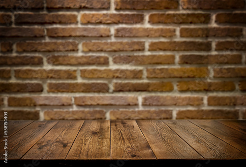 An empty wooden countertop against a red brick wall. Home interior. Copy space