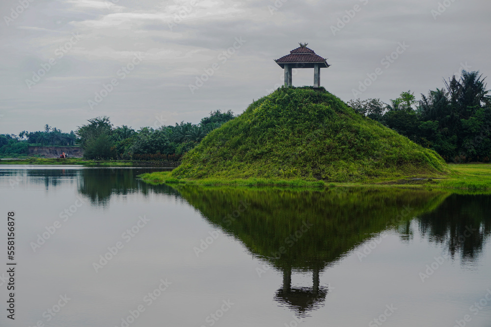 Traditional Gazebo Temple on Top of Green Hill in the middle of the lake