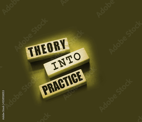 Theory into practice words written on wooden blocks. Education or business startup concept