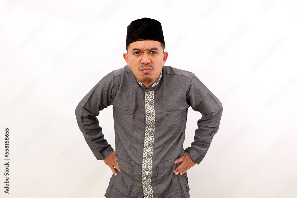 Angry asian muslim man standing against white background Angry asian muslim man standing against white background
