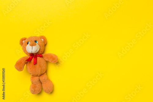 Cute teddy bear on color background, top view © Liami