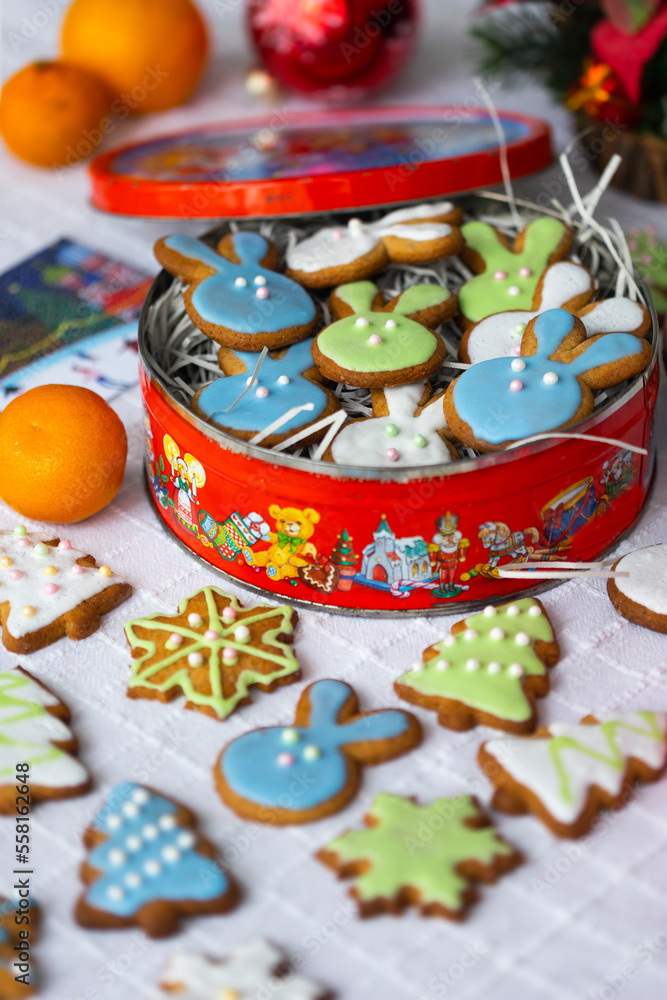 Ginger cookies in shape of rabbits,Christmas trees and snowflakes  with sugar icing - light blue, green, white.