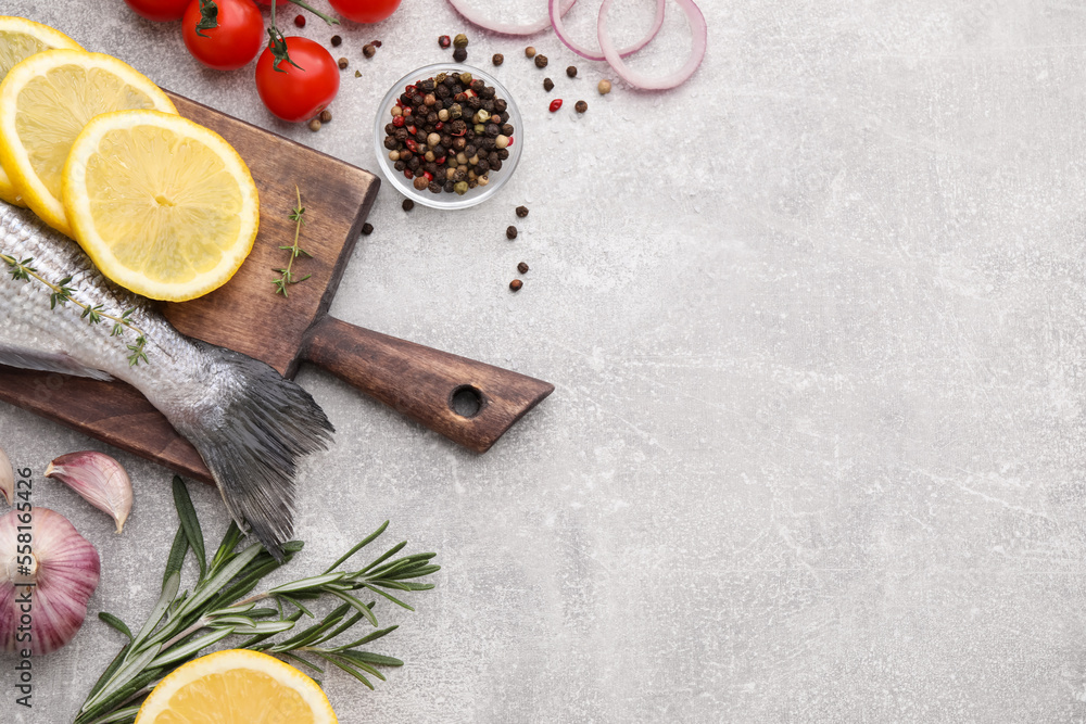 Flat lay composition with fresh raw dorado fish and ingredients on light grey table, space for text Flat lay composition with fresh raw dorado fish and ingredients on light grey table, space for text