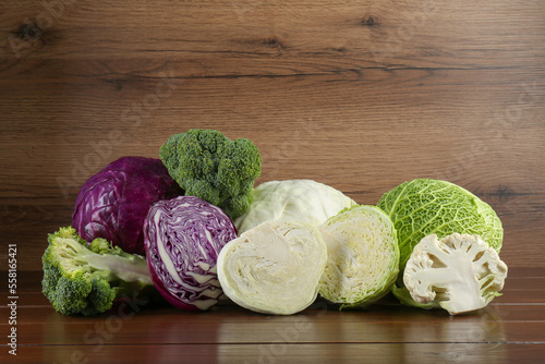 Different types of cabbage on wooden table