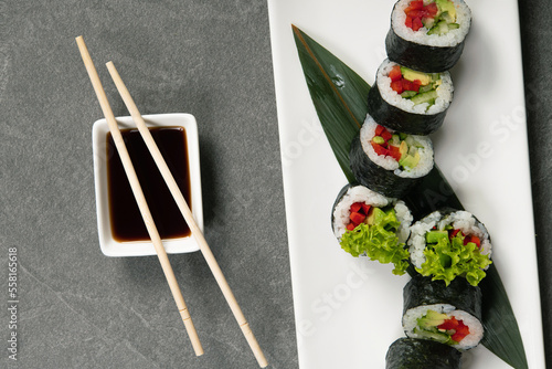 Fresh vegan sushi rolls with pepper, cucumber, avocado.
