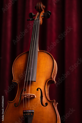 Retro vintage violin on red theater curtains background