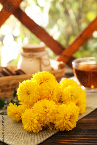 Beautiful yellow chrysanthemum flowers on wooden table