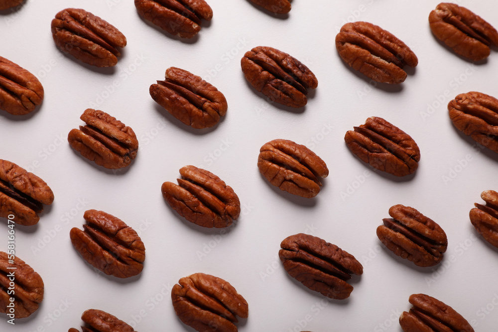 Delicious fresh pecan nuts on white background, flat lay Delicious fresh pecan nuts on white background, flat lay