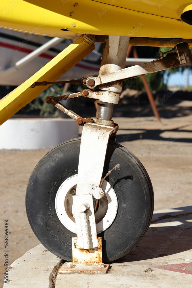 A front tire of a small passenger plane secured to the ground