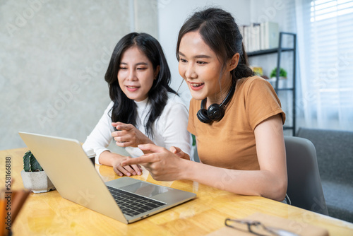 Two Asian female friends meeting for online marketing consulting work in the office room at the company. colleague concept photo