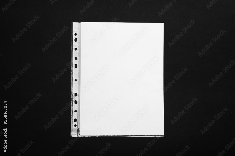 Punched pocket with paper sheet on black background, top view Punched pocket with paper sheet on black background, top view