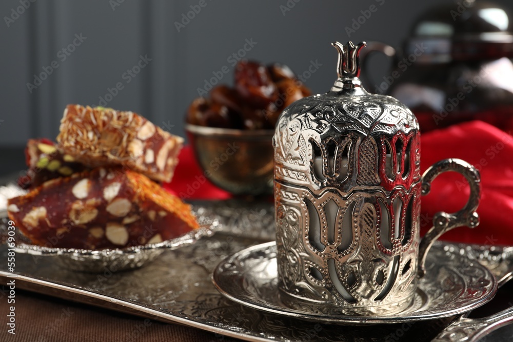 Tea, Turkish delight and date fruits served in vintage tea set on table, space for text