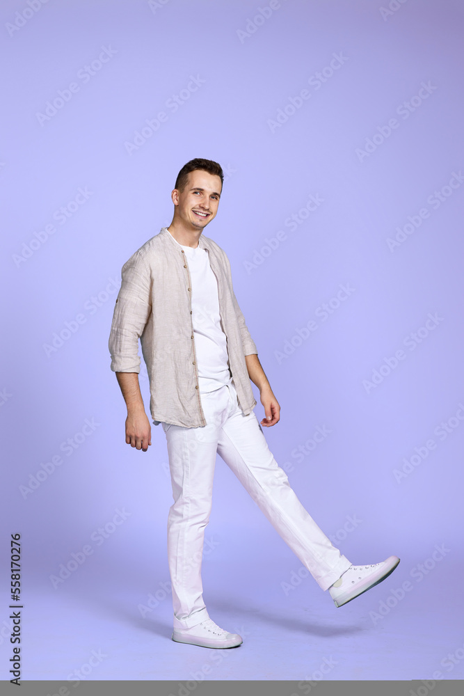 happy man walks isolated on violet background. happy man walks isolated on violet background.