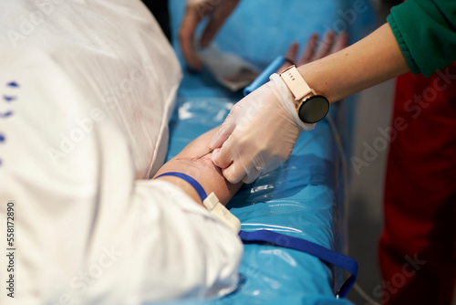 a nurse takes a blood sample.Close up Hand of a nurse or doctor in gloves taking a blood sample from a patient in a hospital. Close up Of Doctor Injecting Patient With Syringe To Collect Blood Sample