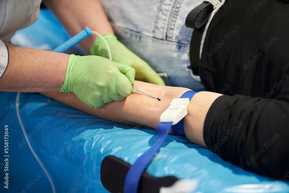 a nurse takes a blood sample.Close up Hand of a nurse or doctor in gloves taking a blood sample from a patient in a hospital. Close up Of Doctor Injecting Patient With Syringe To Collect Blood Sample a nurse takes a blood sample.Close up Hand of a nurse or doctor in gloves taking a blood sample from a patient in a hospital. Close up Of Doctor Injecting Patient With Syringe To Collect Blood Sample