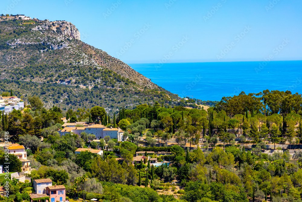 Panoramic view of Eze town valley among Alpes hills and residential area with summer houses and villas on French Riviera Coast of Mediterranean Sea in France