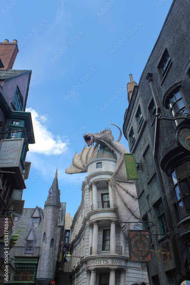 Fototapeta premium Orlando, FL, USA. August 15, 2016: Dragon at the top of the Gringotts Bank. Harry Potter World at Universal Studios