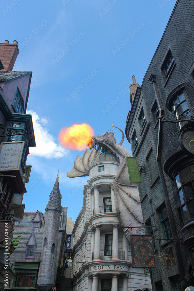 Naklejka premium Orlando, FL, USA. August 15, 2016: Dragon at the top of the Gringotts Bank. Harry Potter World at Universal Studios