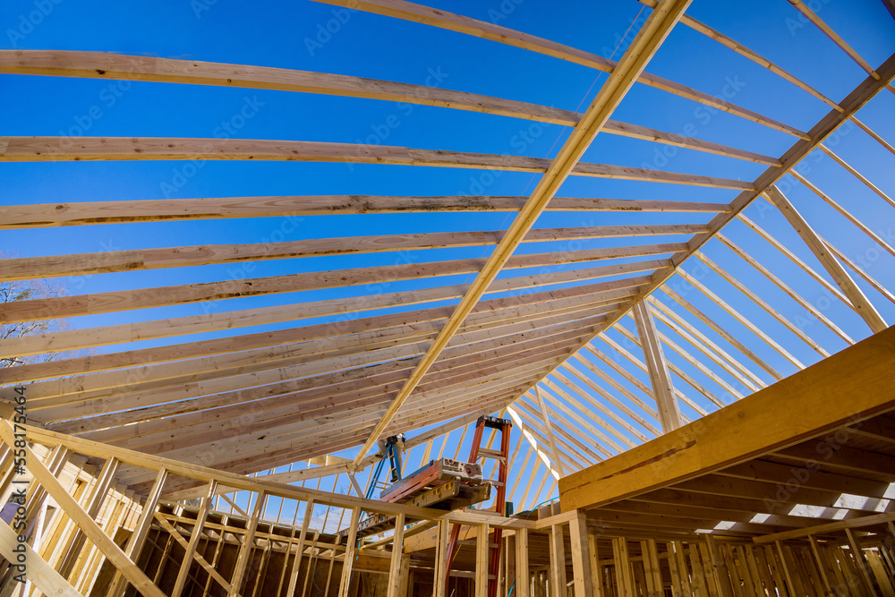 At wood framing beams that are being used in residential building construction constructed new house At wood framing beams that are being used in residential building construction constructed new house